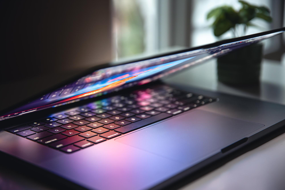 Close up of laptop keyboard colorful neon illumination backlit keyboard